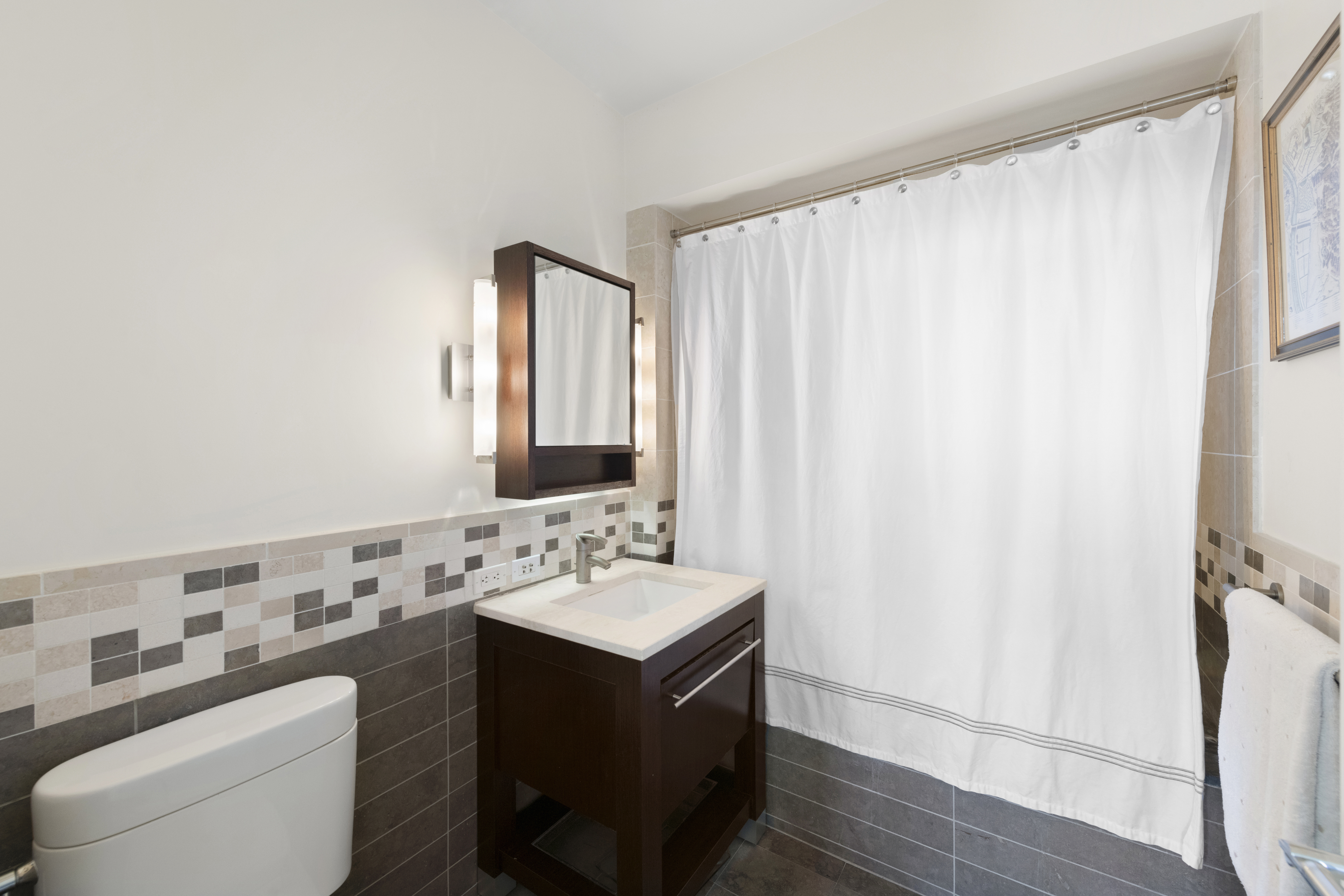 101 West 24th Street, Unit 12C Manhattan, NY 10011 - Photo 6 of 17 a bathroom with a sink and a mirror