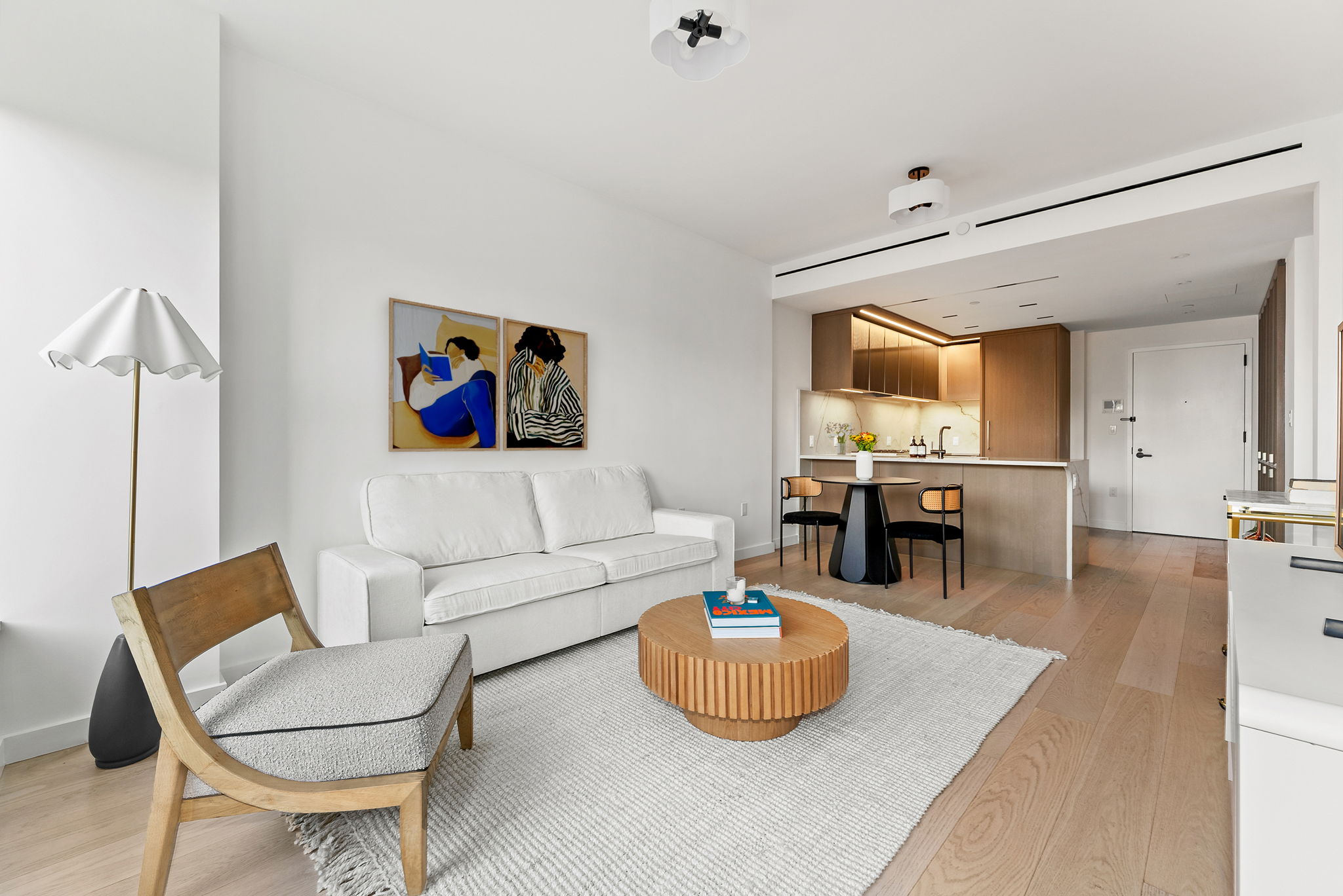 a living room with furniture and a view of kitchen