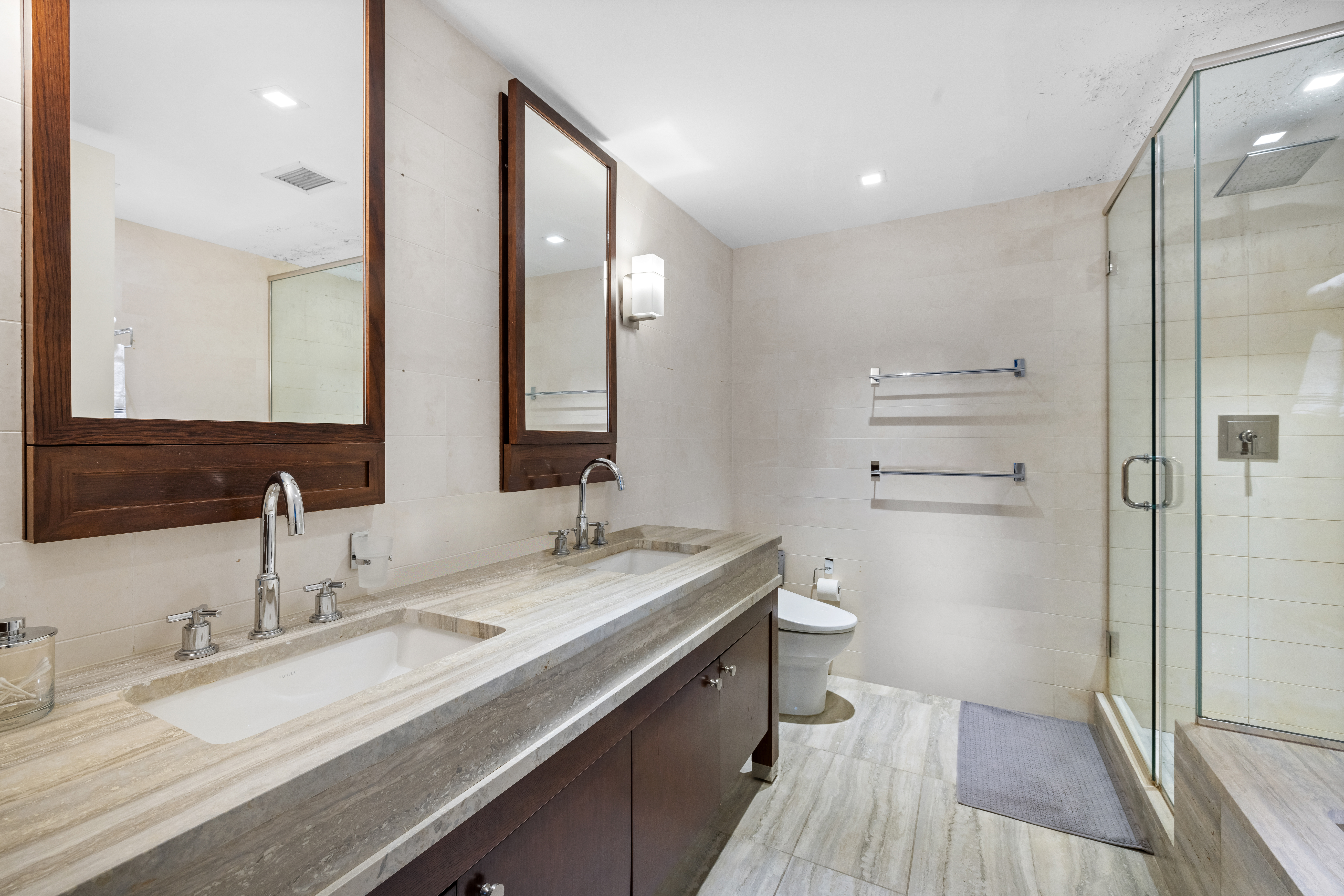 80 Riverside Boulevard, Unit 7E Manhattan, NY 10069 - Photo 7 of 12 a bathroom with a granite countertop sink a toilet and a large mirror
