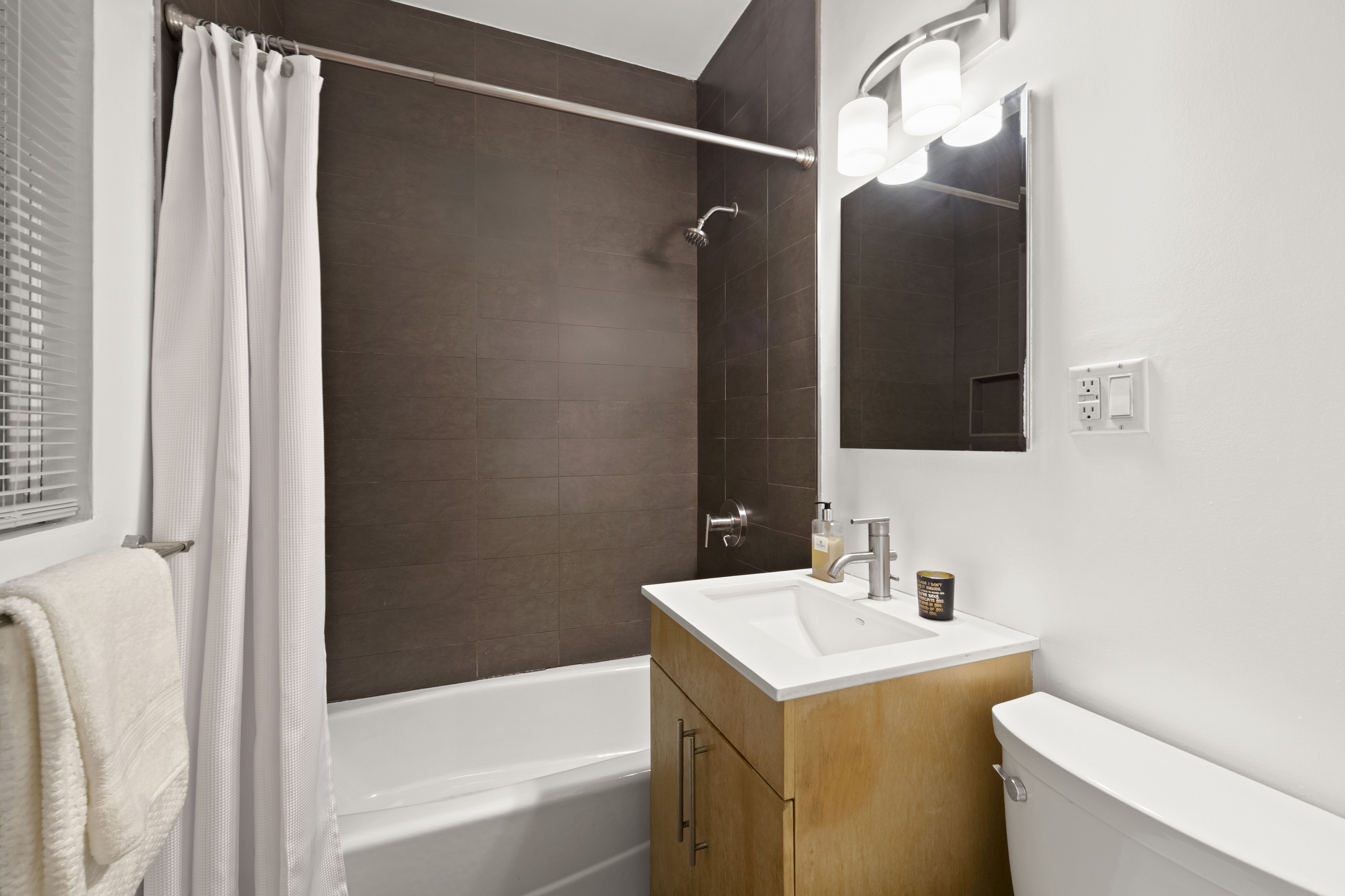 406 West 46th Street, Unit 1B Manhattan, NY 10036 - Photo 6 of 8 a bathroom with a sink and a mirror