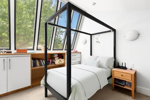 a bedroom with a bed and a window