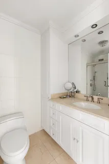 a bathroom with a granite countertop sink a toilet and a mirror