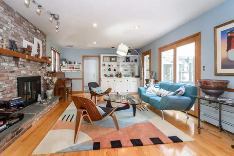 a workspace with furniture a fireplace and a window