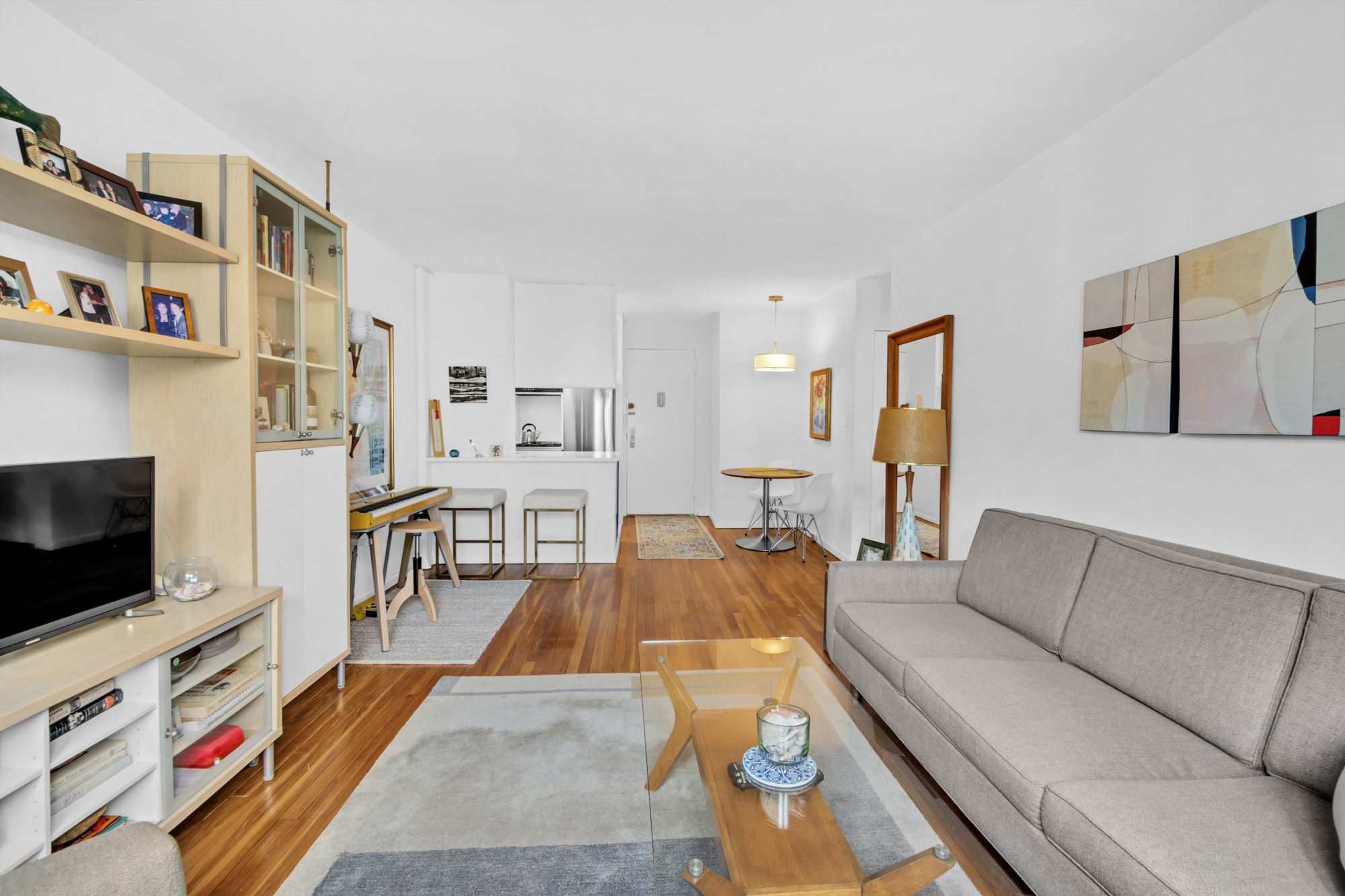 100 Overlook Terrace, Unit 85 Manhattan, NY 10040 - Photo 5 of 8 a living room with furniture and a flat screen tv