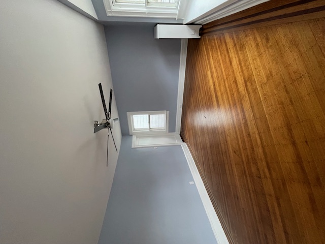 340 Marlborough Road Brooklyn, NY 11226 - Photo 14 of 27 an empty room with wooden floor and windows