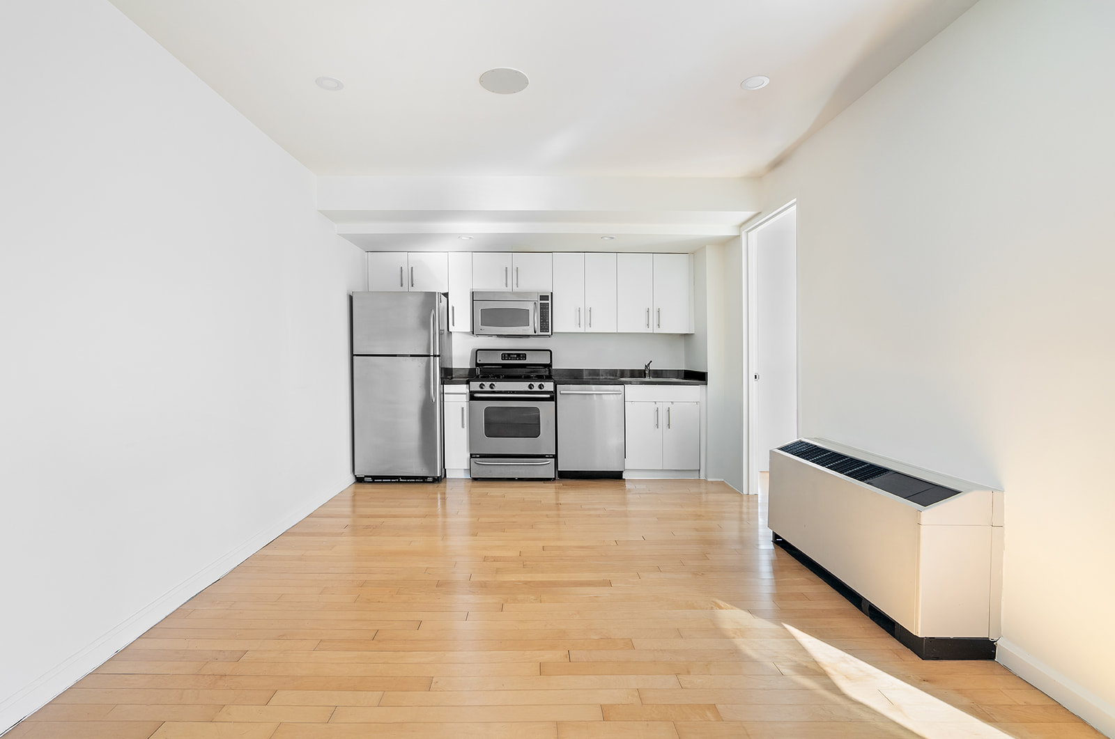 20 West Street, Unit 28F Manhattan, NY 10004 - Photo 4 of 18 a kitchen with stainless steel appliances a refrigerator and a stove