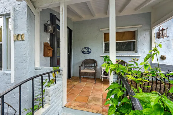 a front view of a house with outdoor seating