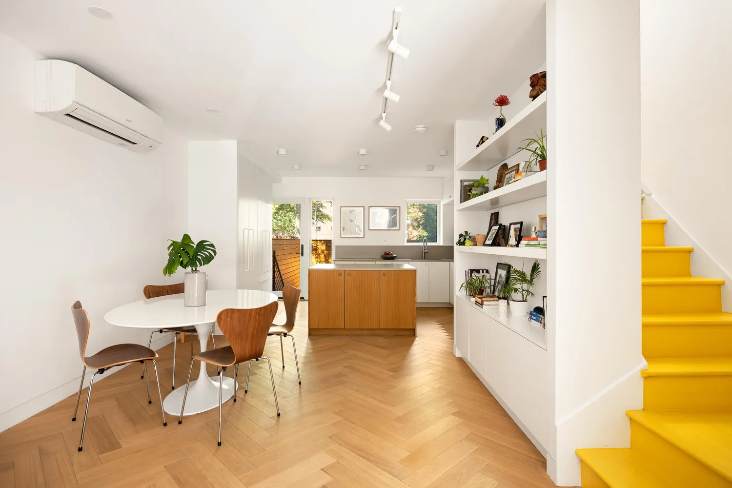 a living room with furniture a rug and white walls