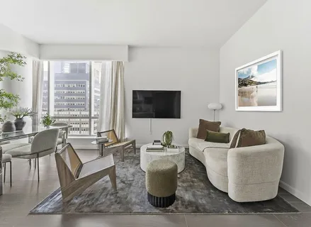 a living room with couches and a flat screen tv