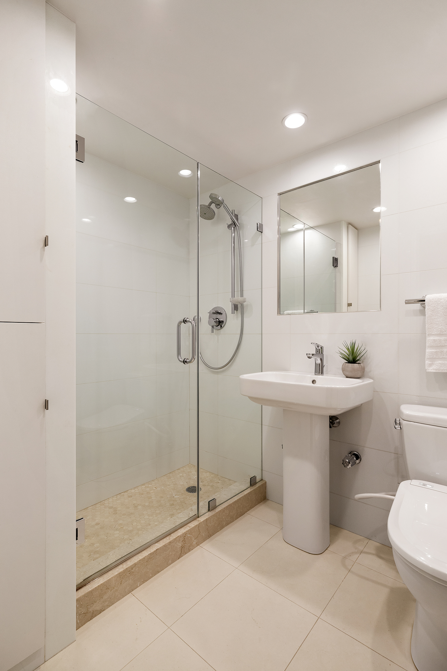 180 East End Avenue, Unit 1C Manhattan, NY 10128 - Photo 11 of 19 a bathroom with a sink mirror and a shower