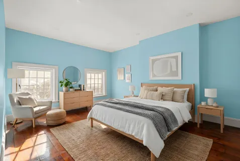 a bedroom with a bed and a couch