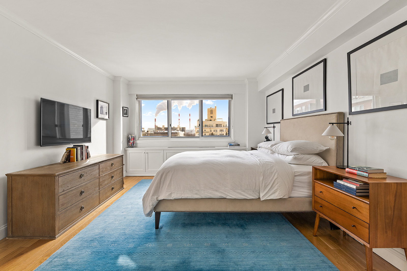 401 East 65th Street, Unit 11HI Manhattan, NY 10065 - Photo 6 of 10 a spacious bedroom with a bed and a flat screen tv
