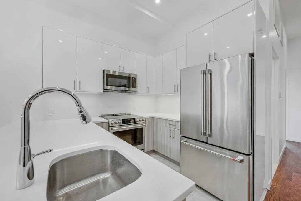 109 President Street, Unit 2 Brooklyn, NY 11231 - Photo 4 of 20 a kitchen with stainless steel appliances granite countertop a refrigerator and a sink
