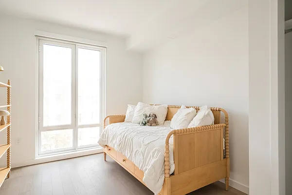 975 Nostrand Avenue, Unit 429 Brooklyn, NY 11225 - Photo 6 of 19 a bed sitting in a bedroom next to a window