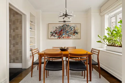a view of a dining room with furniture and a window