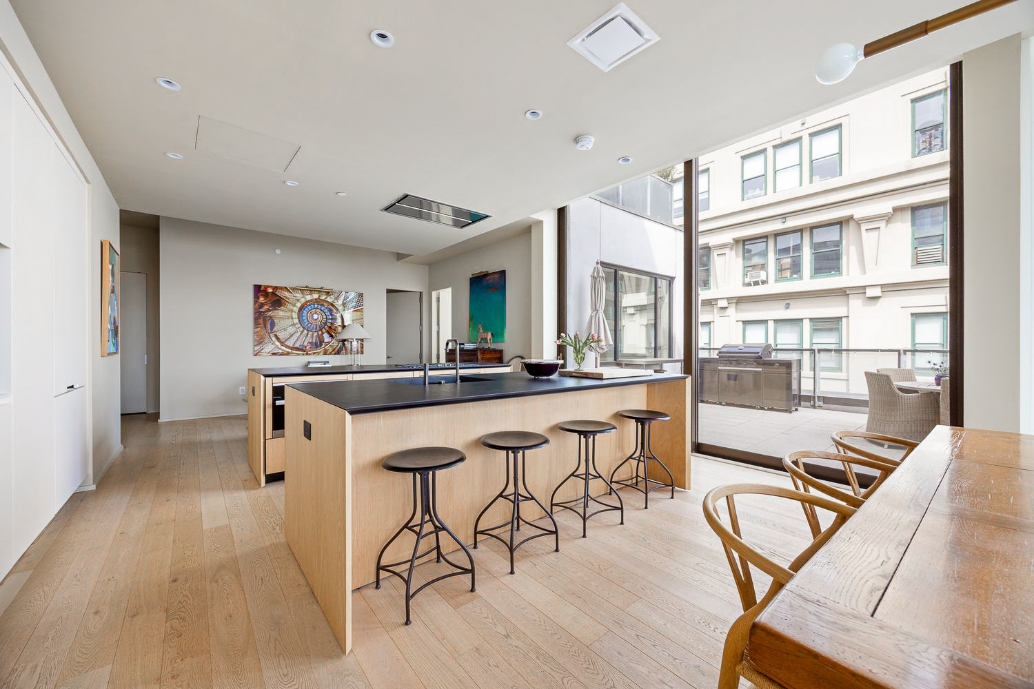 168 Plymouth Street, Unit PHC Brooklyn, NY 11201 - Photo 8 of 19 a dining hall with stainless steel appliances kitchen island granite countertop a dining table chairs and a refrigerator