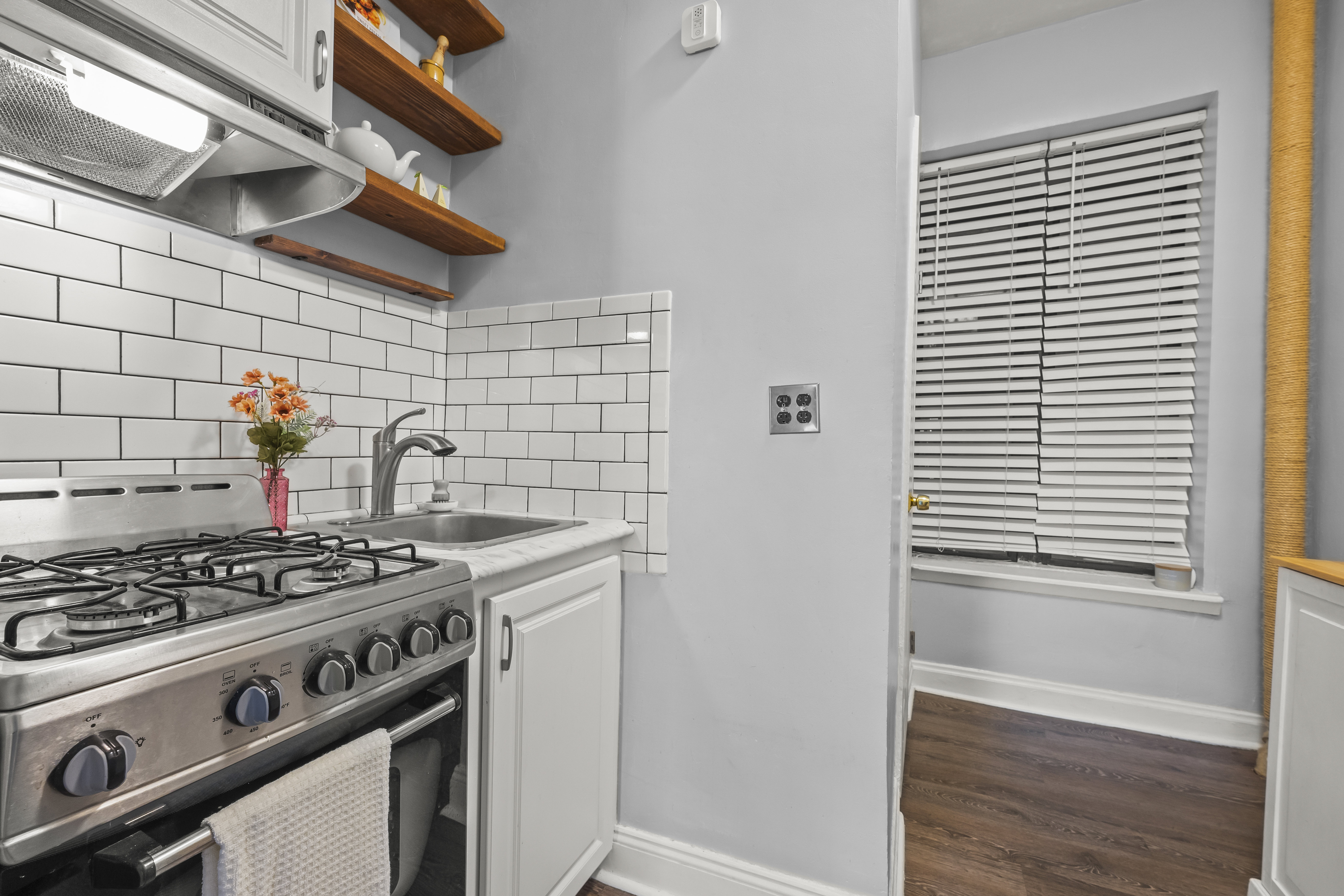 1777 Madison Avenue, Unit 24 Manhattan, NY 10035 - Photo 5 of 20 a kitchen with a stove and a wooden floor