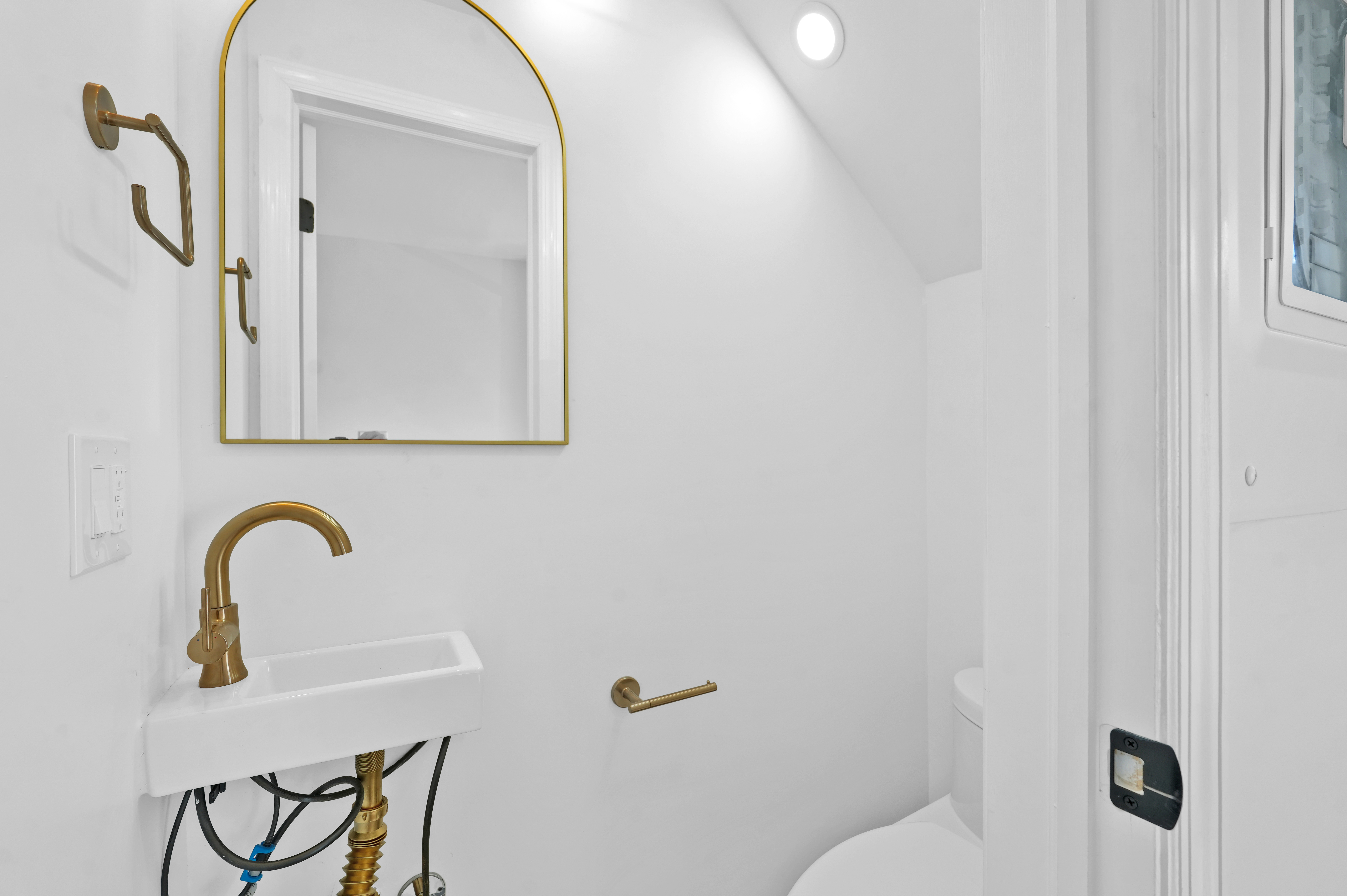 473 Monroe Street Brooklyn, NY 11221 - Photo 11 of 40 a bathroom with a sink a toilet and a mirror