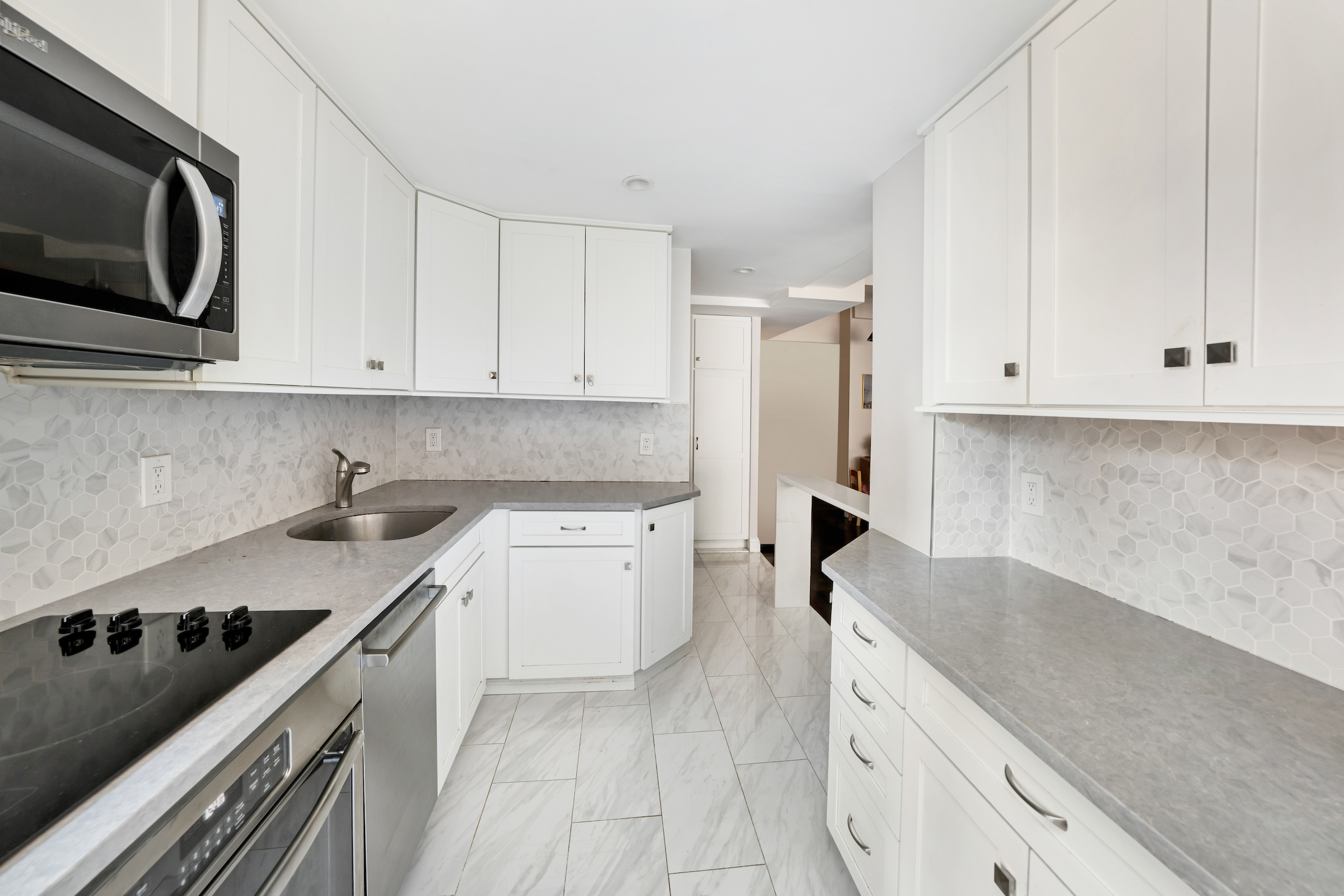 2 Tudor City Place, Unit 11KN Manhattan, NY 10017 - Photo 4 of 14 a kitchen with a sink stove and cabinets