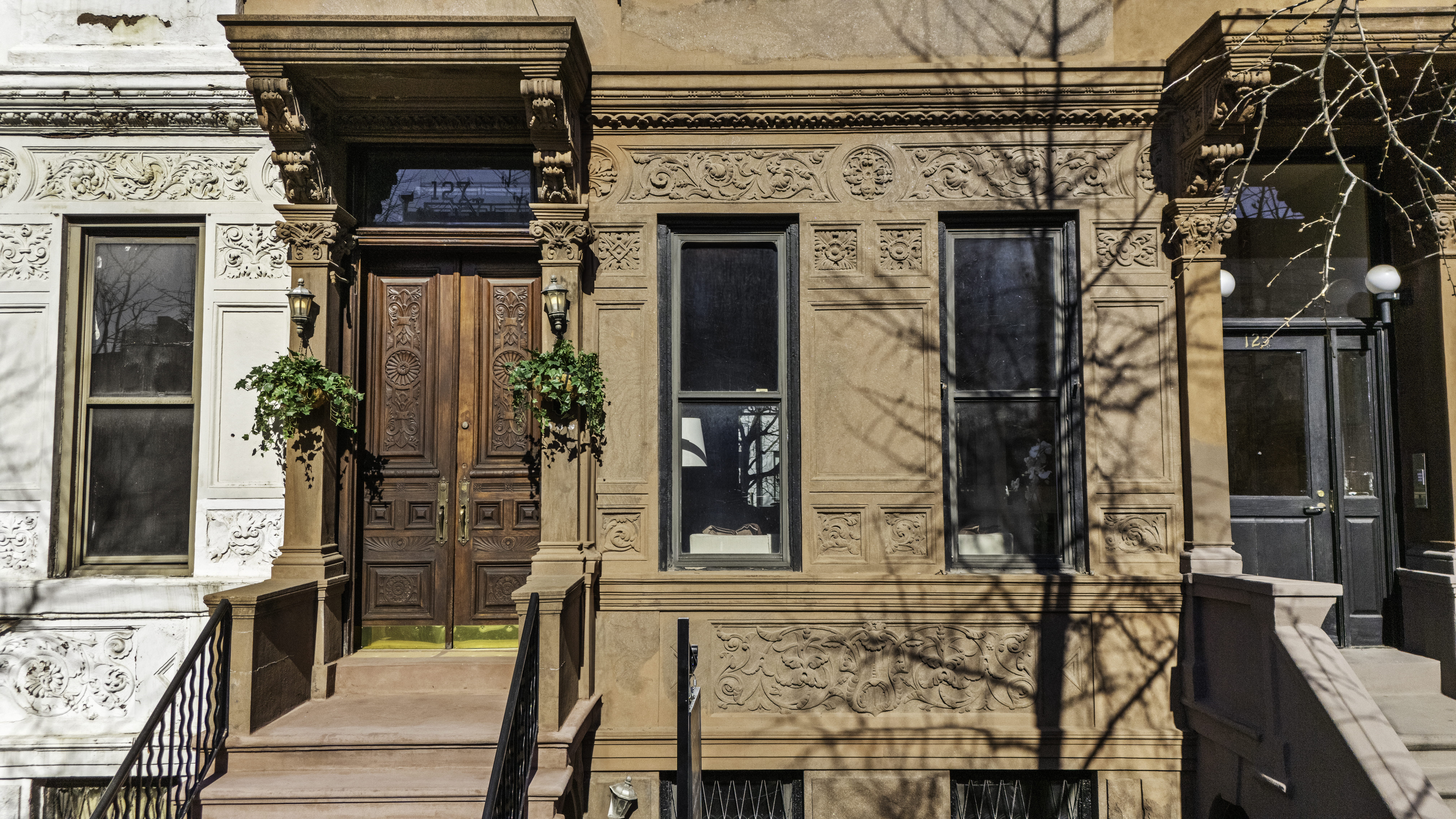 127 West 122nd Street Manhattan, NY 10027 - Photo 15 of 17 front view of a house with a potted plant and a window
