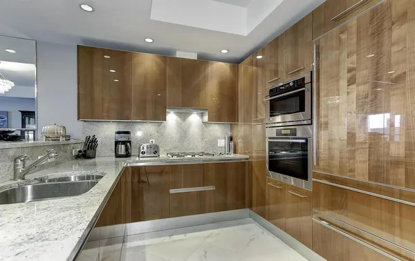 a kitchen with stainless steel appliances granite countertop a sink stove and refrigerator