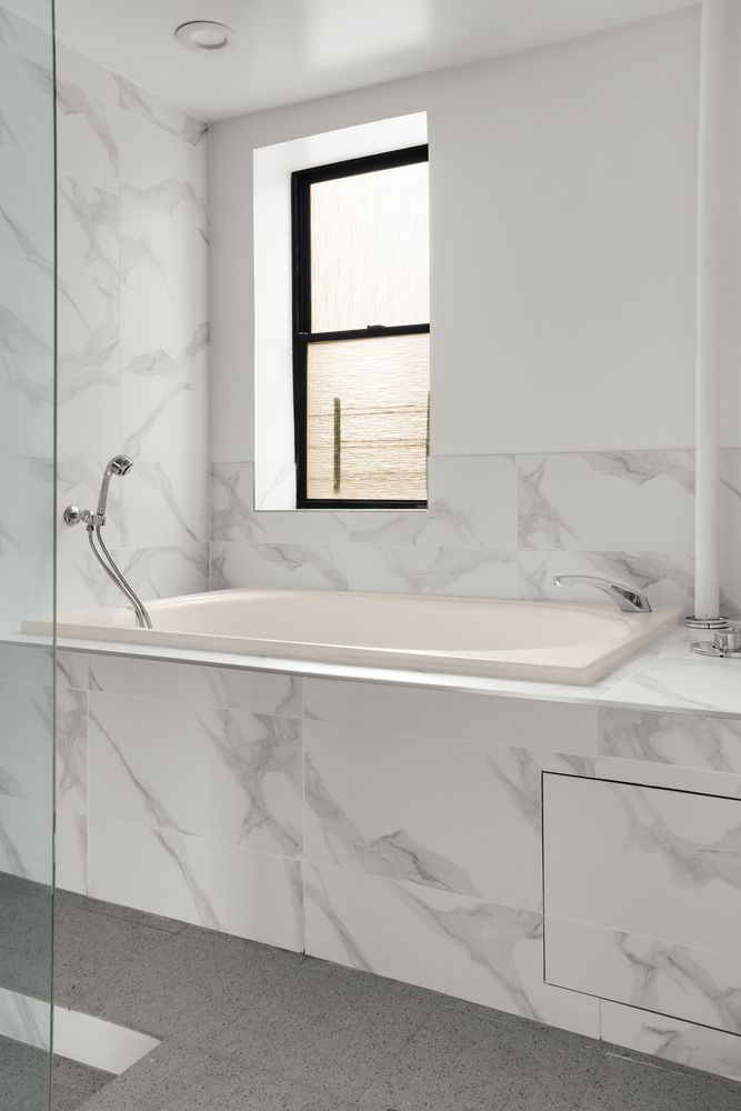 a bathroom with a bathtub and window