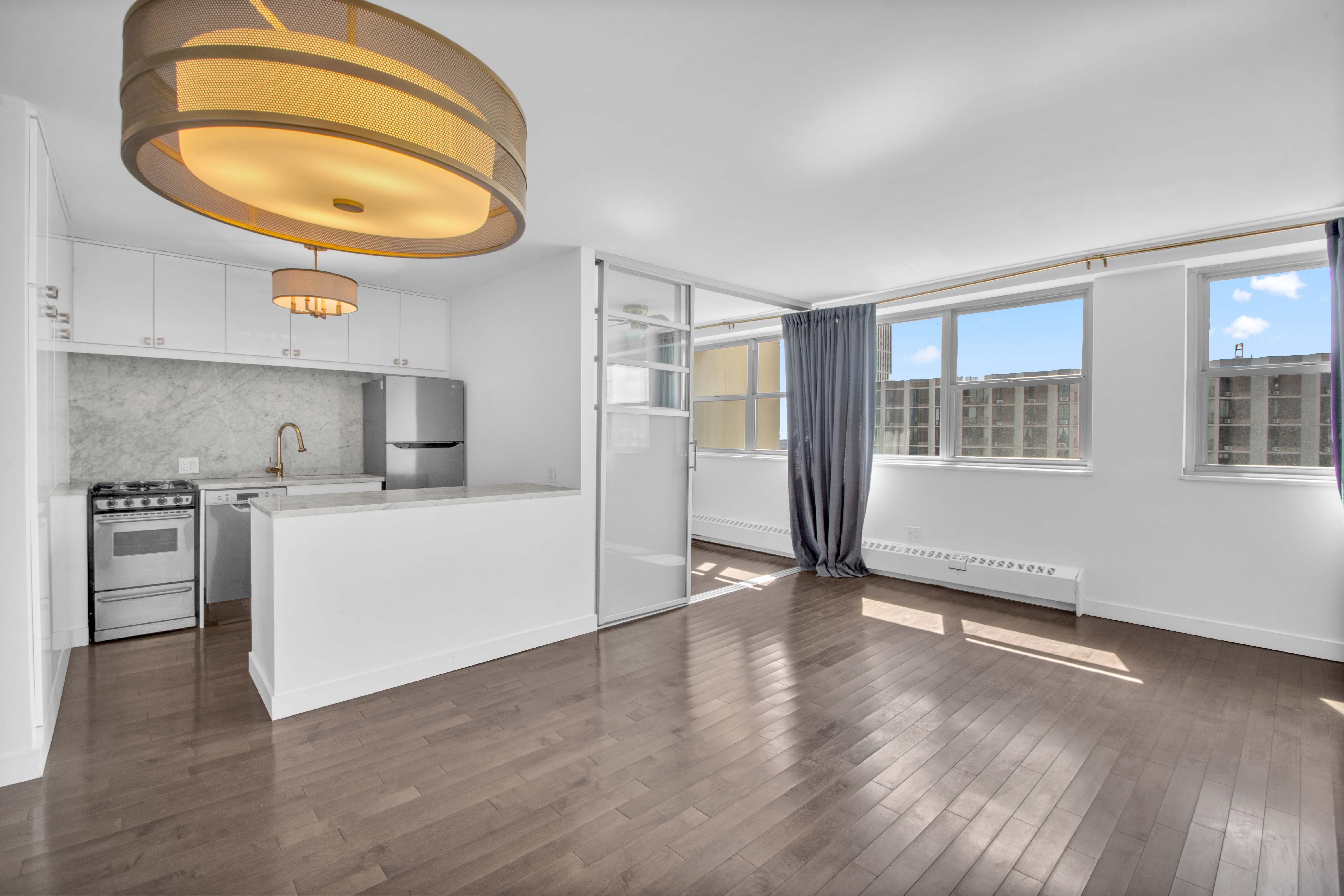 75 Henry Street, Unit 29J Brooklyn, NY 11201 - Photo 5 of 16 a view of a kitchen with wooden floor and a sink
