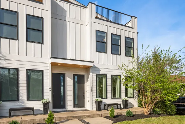 a view of a building with a tree front of house