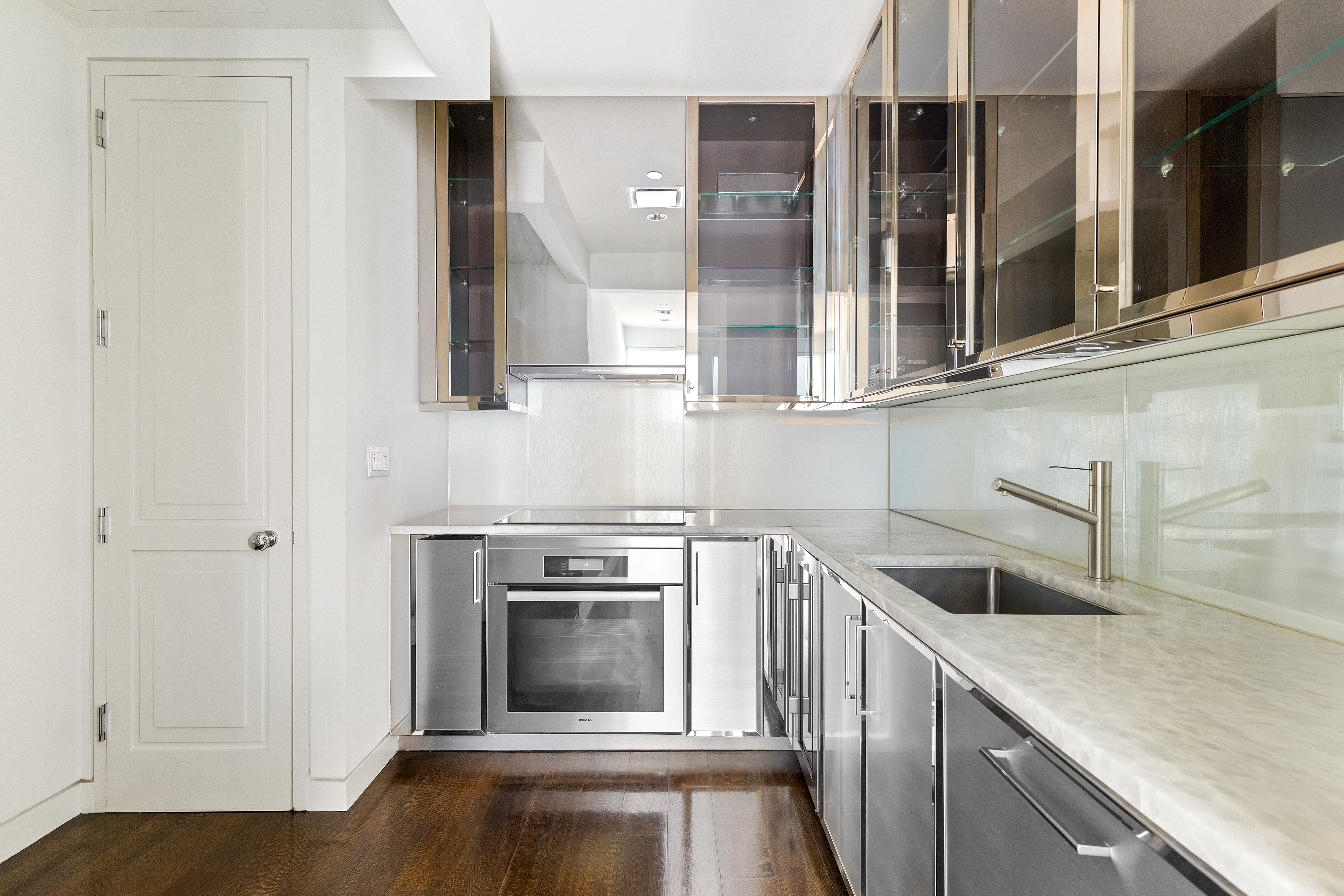 20 West 53rd Street, Unit 22A Manhattan, NY 10019 - Photo 6 of 16 a kitchen with a stove microwave and a sink
