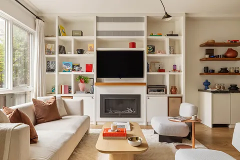 a living room with furniture fireplace and flat screen tv
