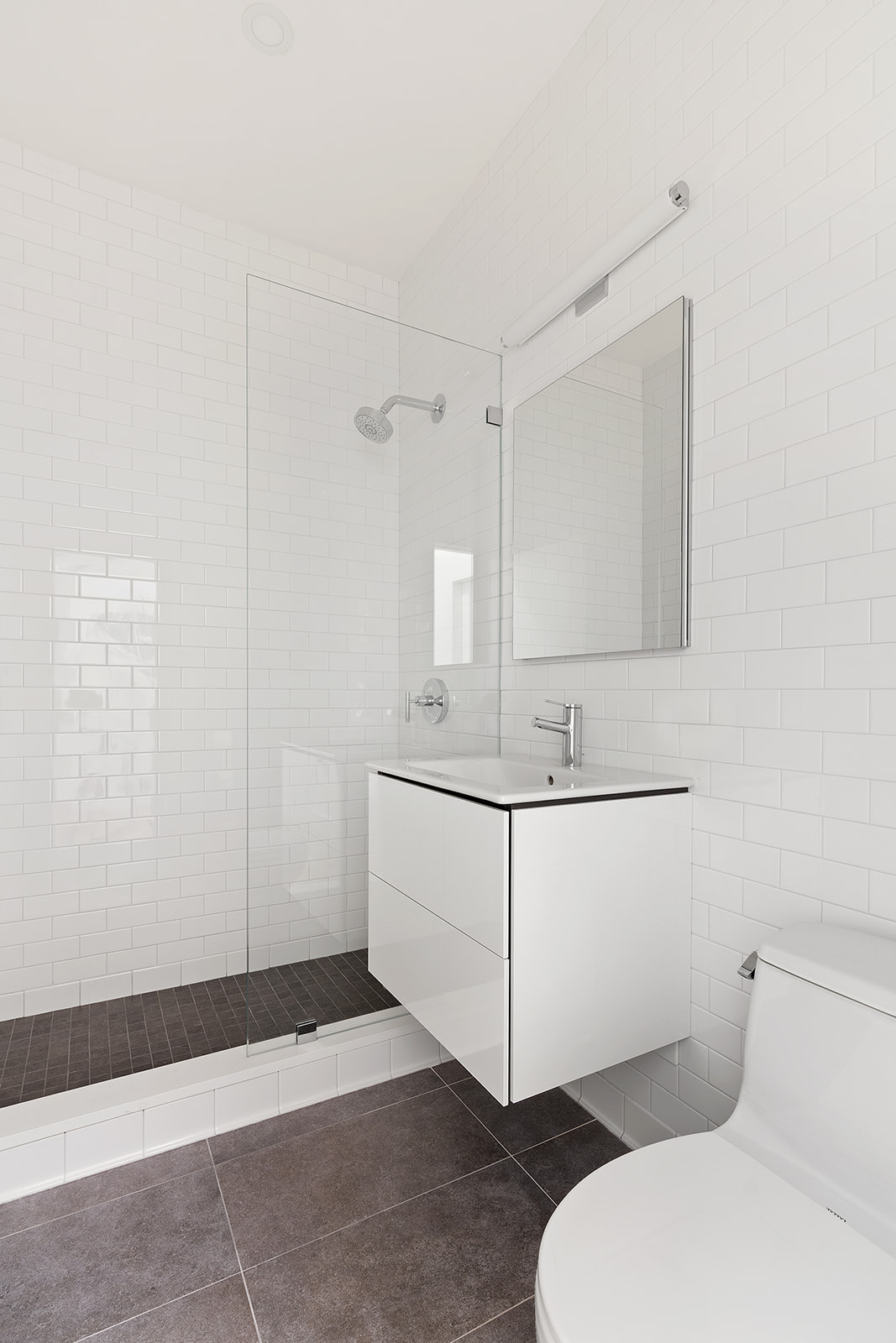 315 7th Avenue, Unit 11E Manhattan, NY 10001 - Photo 6 of 7 a bathroom with a sink a toilet and mirror