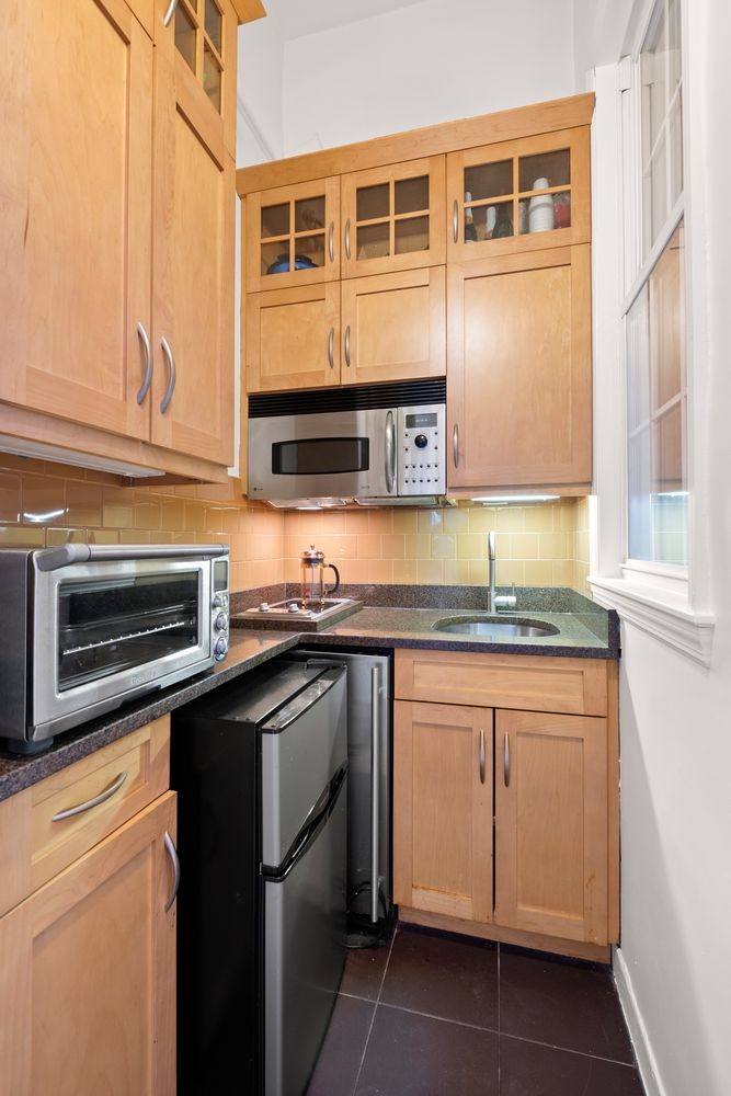 a kitchen with stainless steel appliances granite countertop a stove and a microwave