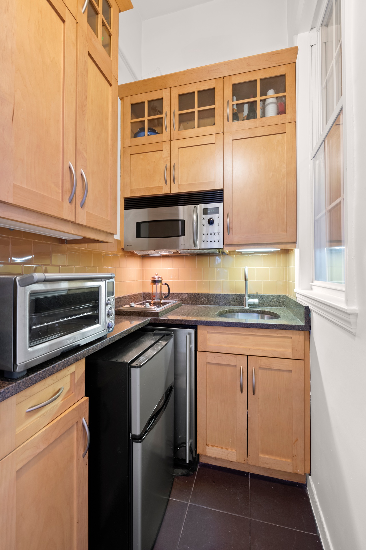 39 5th Avenue, Unit 1B Manhattan, NY 10003 - Photo 6 of 7 a kitchen with stainless steel appliances granite countertop a stove and a microwave