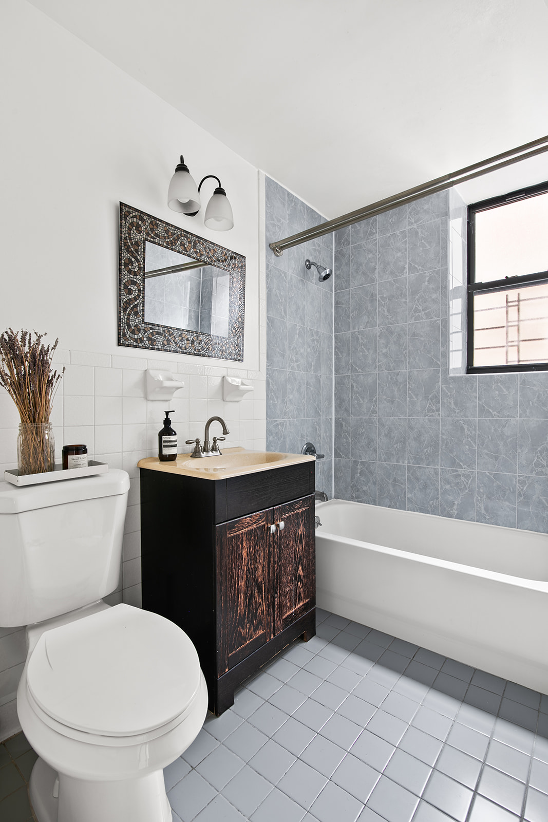 660 St Nicholas Avenue, Unit 54 Manhattan, NY 10030 - Photo 5 of 9 a bathroom with a toilet a sink a mirror and bathtub