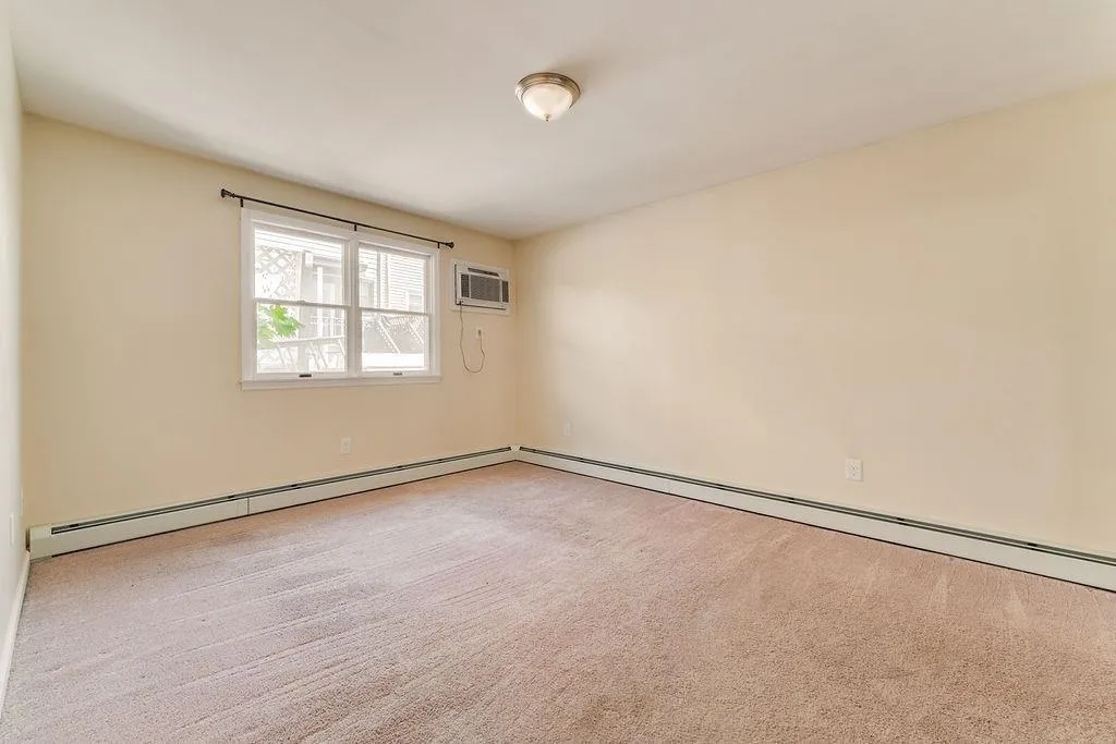 an empty room with a empty space and a window