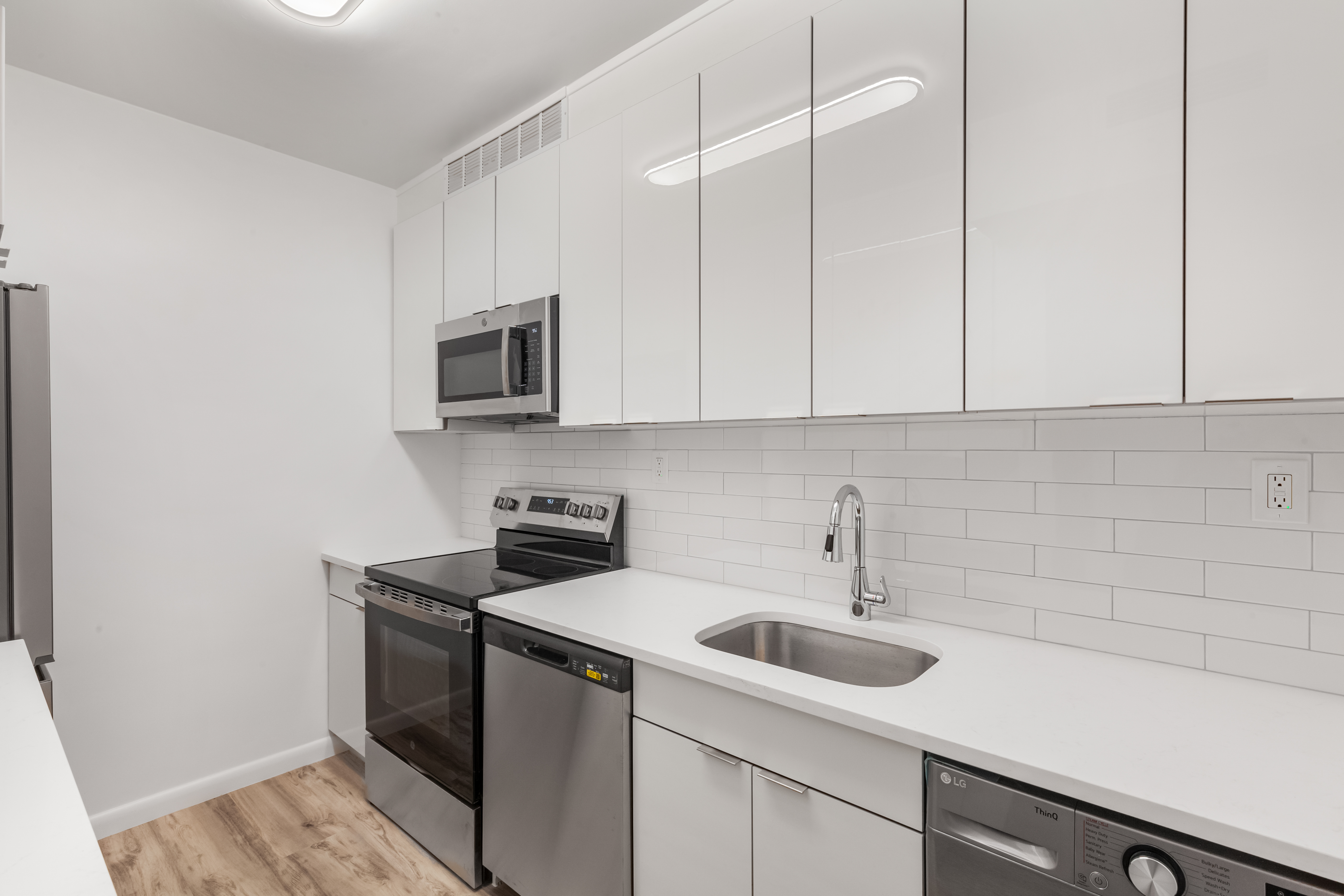 175 East 62nd Street, Unit 10B Manhattan, NY 10065 - Photo 4 of 12 a kitchen with a sink and cabinets