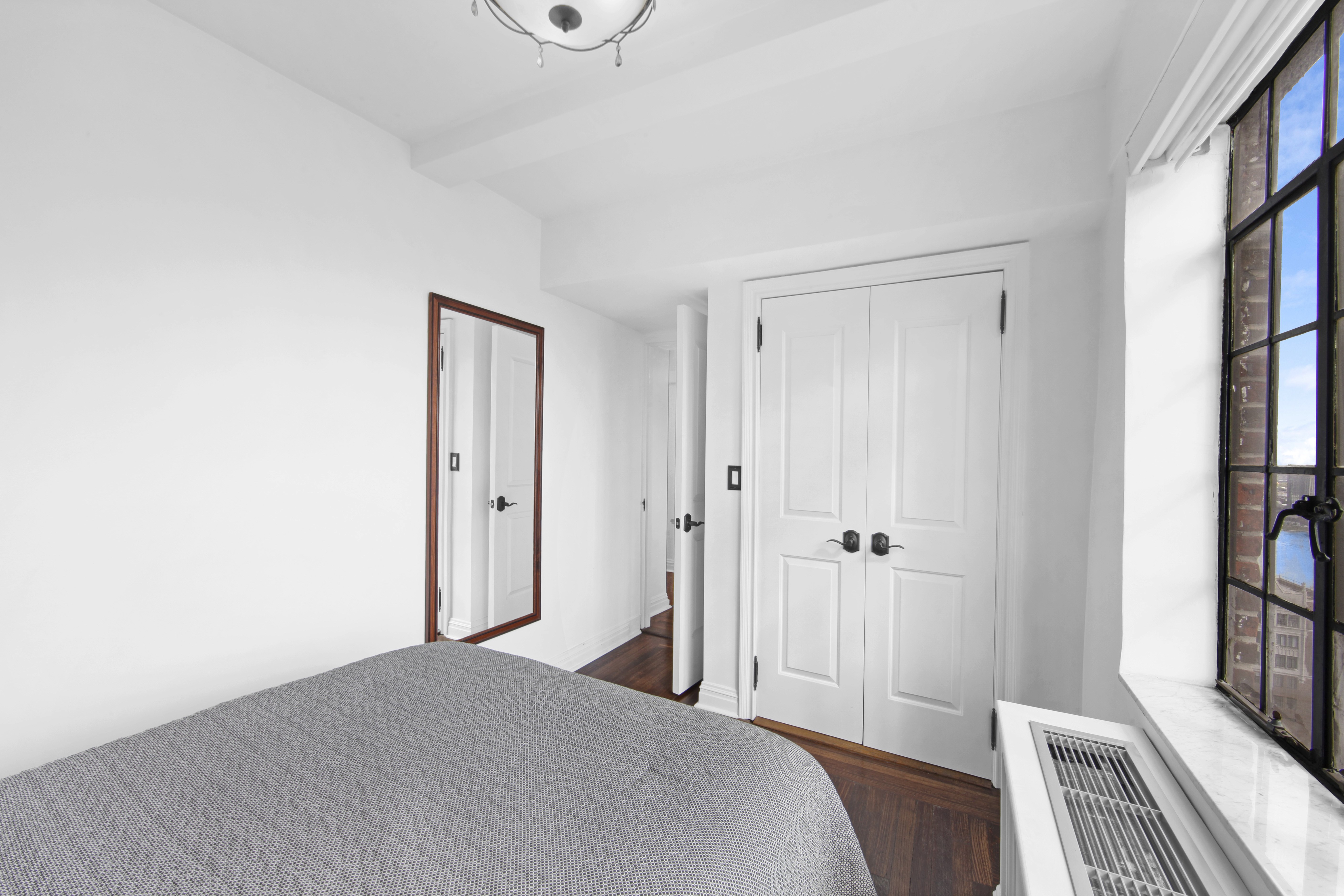 320 East 42nd Street, Unit 3012 Manhattan, NY 10017 - Photo 10 of 12 a bedroom with a bed and a window