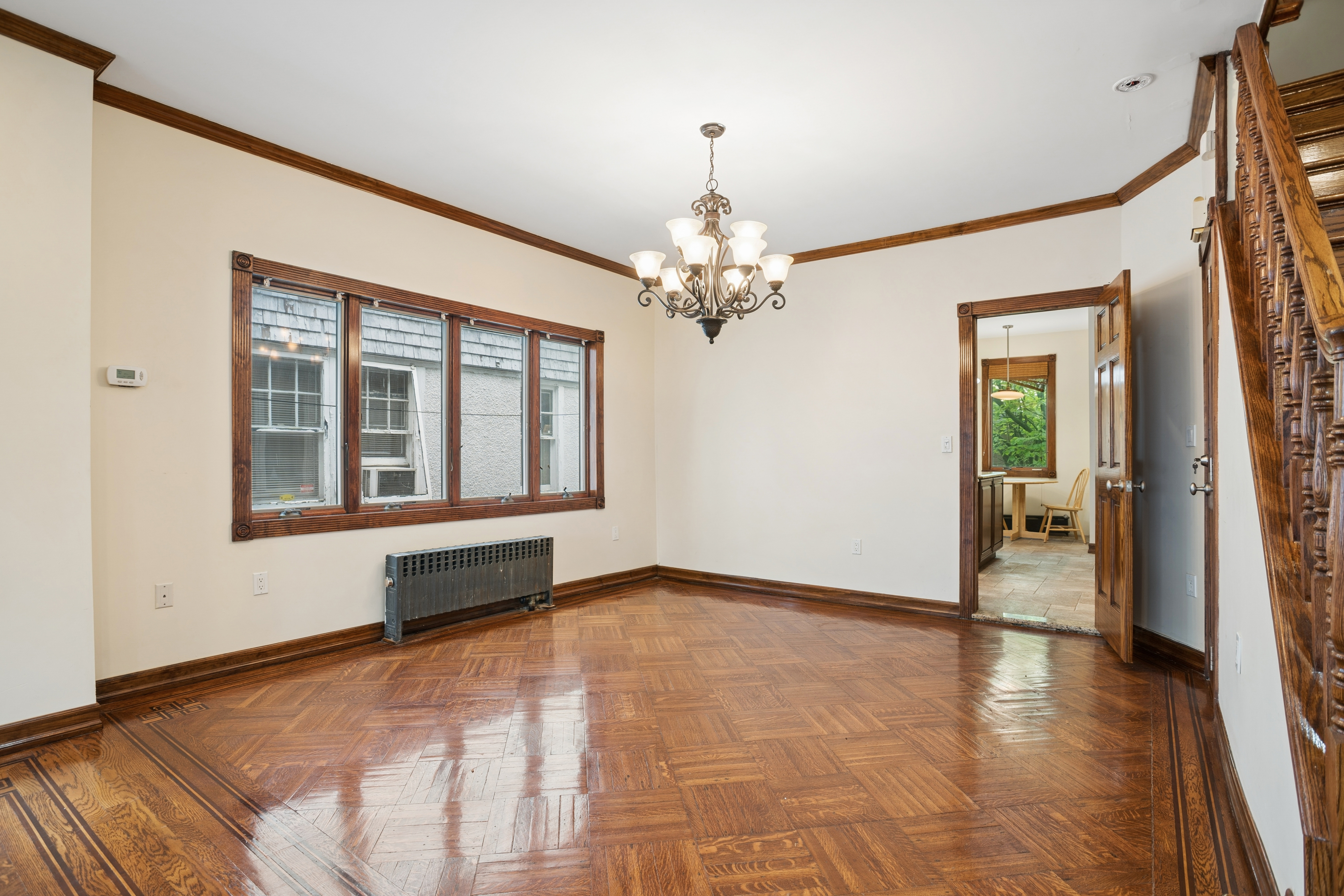 1982 East 23rd Street Brooklyn, NY 11229 - Photo 6 of 16 a view of an empty room with wooden floor and a window