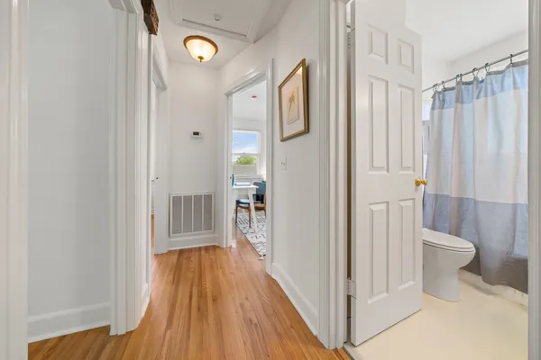 a view of a bathroom with a toilet and a shower