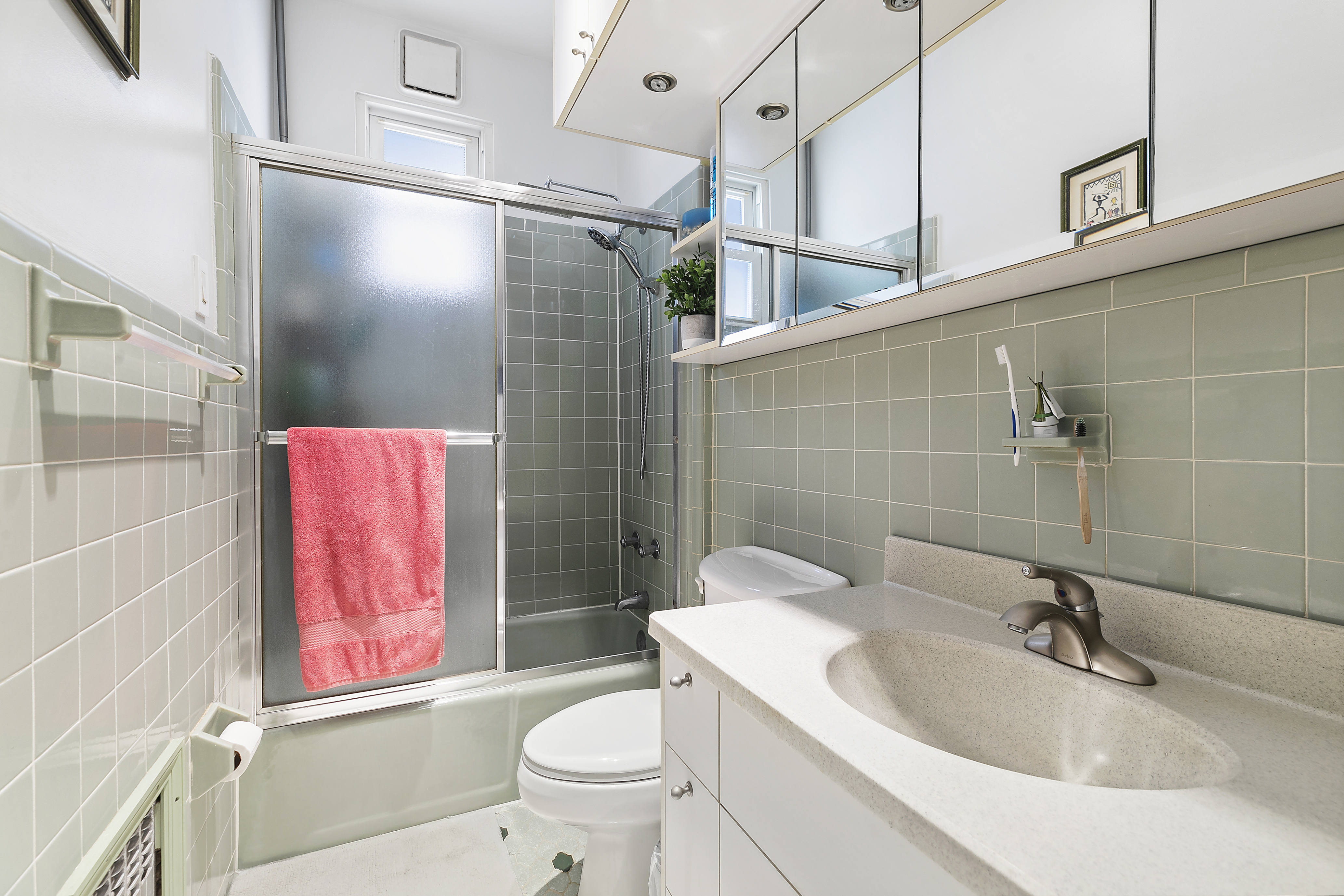 60-38 68th Road Queens, NY 11385 - Photo 11 of 14 a bathroom with a sink toilet and shower