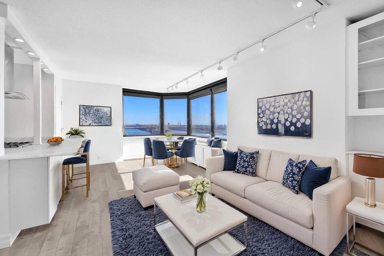 a living room with furniture a rug and a table