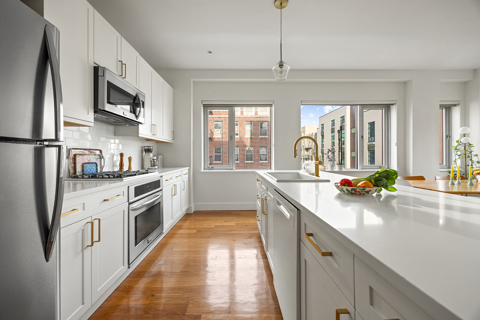 432 Grand Street, Unit 402 Brooklyn, NY 11211 - Photo 3 of 12 a kitchen with stainless steel appliances a sink a stove and a refrigerator