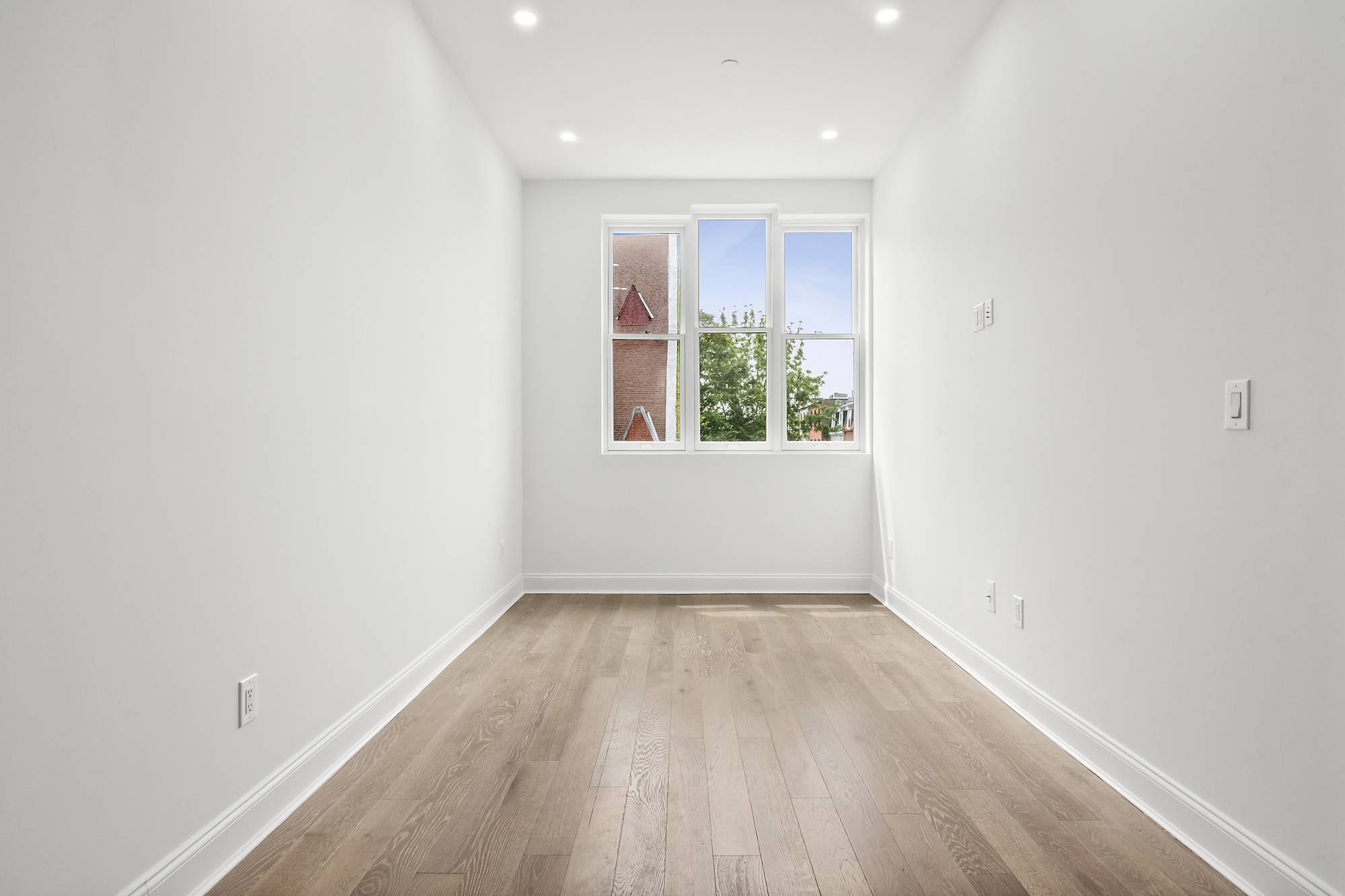 467 Tompkins Avenue, Unit 3A Brooklyn, NY 11216 - Photo 8 of 12 an empty room with wooden floor and windows