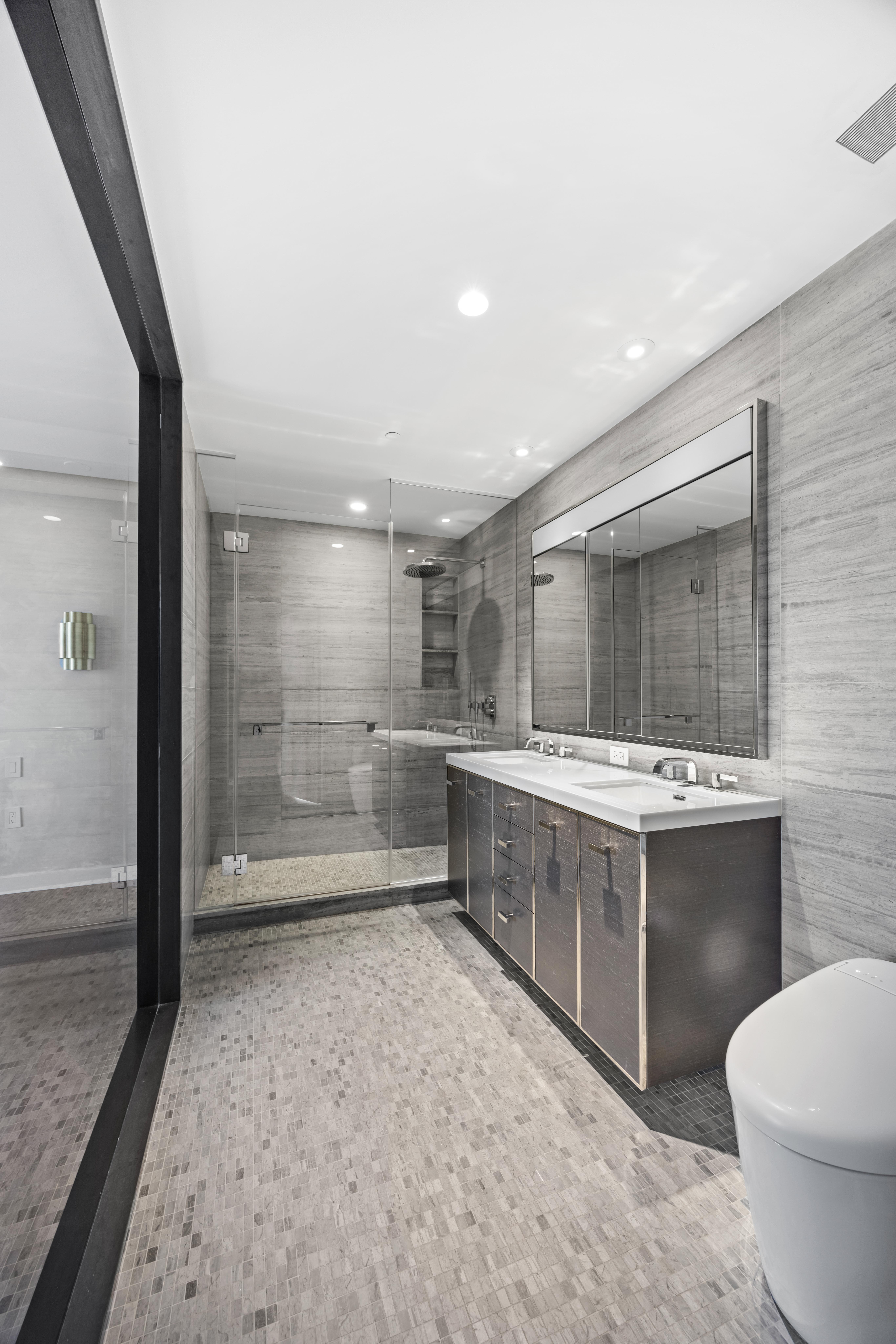 252 South Street, Unit 61A Manhattan, NY 10002 - Photo 6 of 29 a bathroom with a sink and mirror