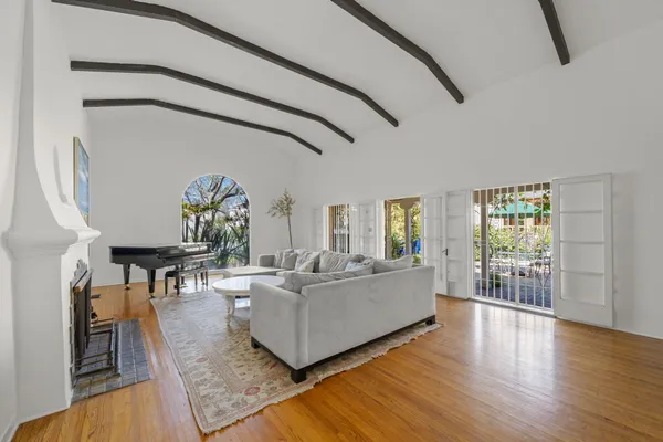 a living room with furniture and wooden floor