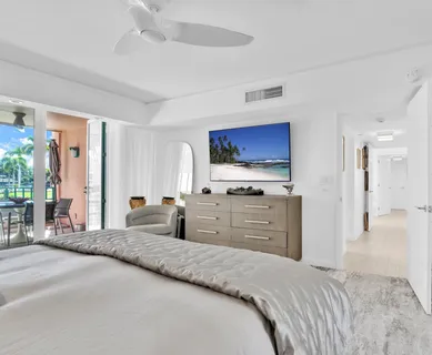 a bedroom with furniture and a flat screen tv