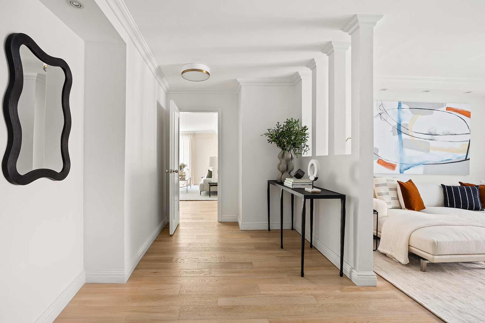 69 West 9th Street, Unit 2B Manhattan, NY 10011 - Photo 9 of 18 a living room with furniture a potted plant and a wooden floor