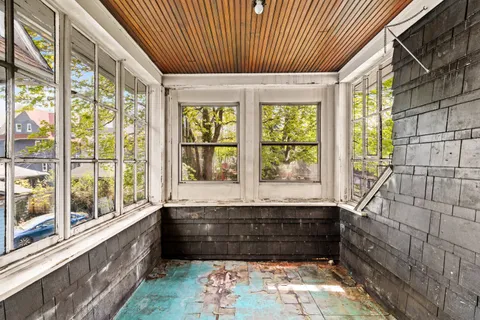 a view of staircase with railing and white walls