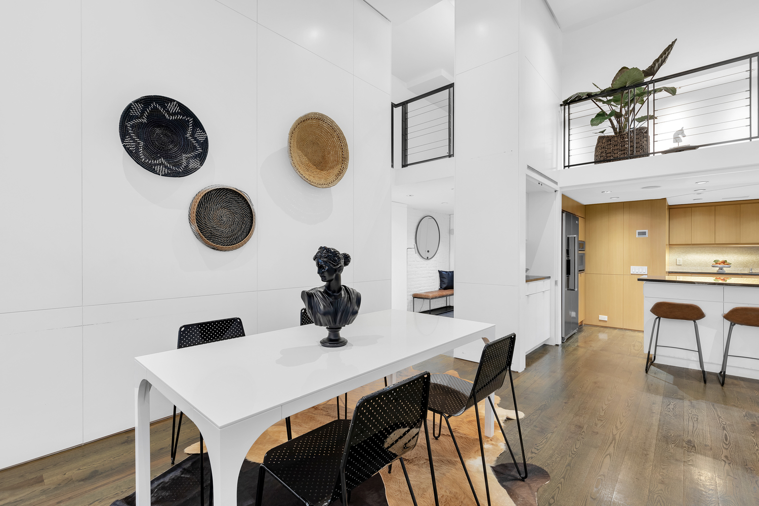 200 Mercer Street, Unit MAIS-G Manhattan, NY 10012 - Photo 4 of 17 a view of a dining room with furniture and wooden floor