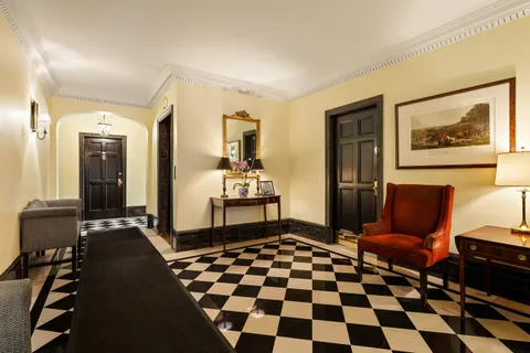 a living room with a black white checkered floor with a black white checkered floor